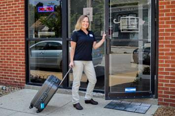 Mobile sonographer entering veterinary clinic